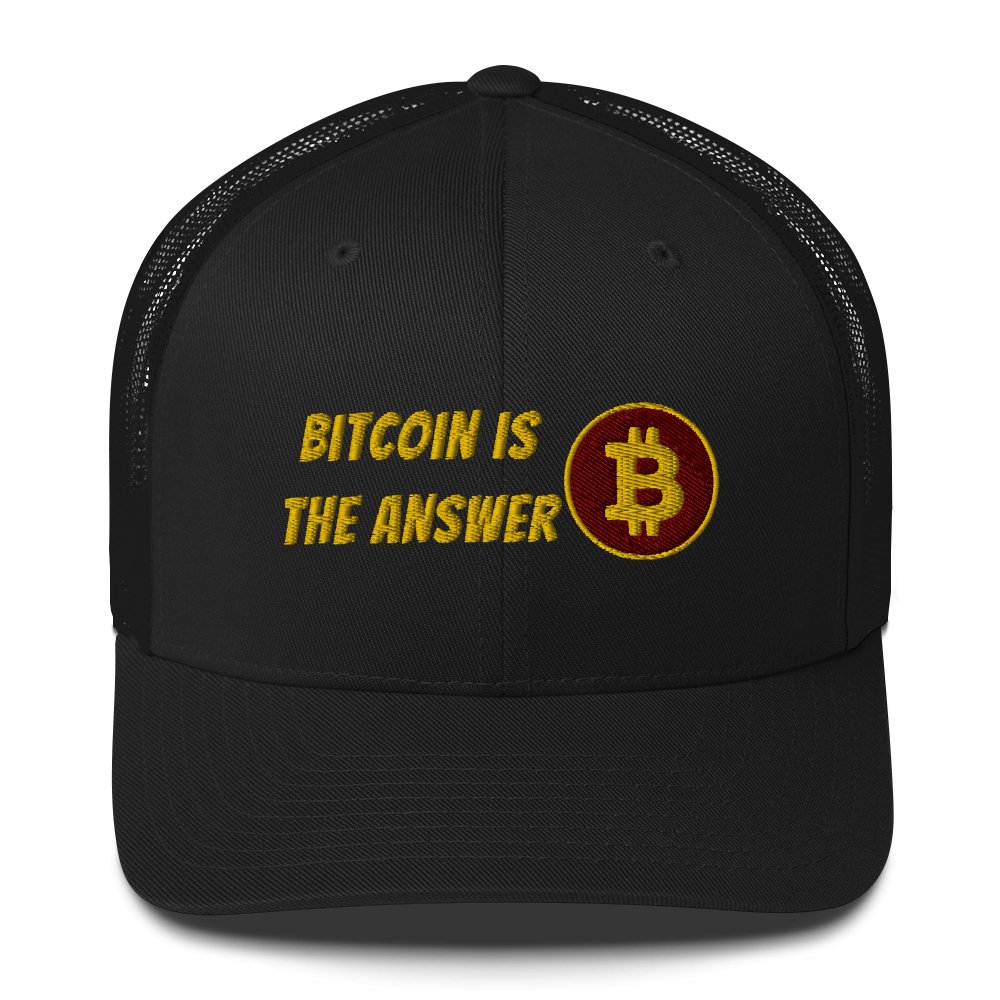 A black Bitcoin trucker cap with mesh backing featuring the phrase "Bitcoin is the Answer" embroidered in gold thread alongside a golden UTXO Dreams emblem.