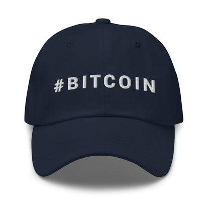 Introducing the Hashtag Hat: a sleek black baseball cap with "#BITCOIN" elegantly embroidered in striking white capital letters across the front. Ideal for crypto enthusiasts roaming vibrant cities such as Sydney and Melbourne, this cap boasts a curved brim and detailed stitching on each panel and the brim.