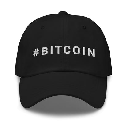 Introducing the Hashtag hat: a sleek black baseball cap adorned with the prominent hashtag "#BITCOIN" embroidered in striking white capital letters across the front. This cap, ideal for wandering through Sydney or discovering Melbourne, features a curved brim and visible stitching that adds to its contemporary and minimalist style.