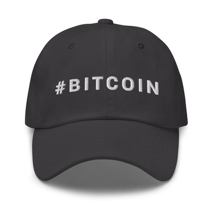 The Hashtag hat, a black baseball cap with "#BITCOIN" embroidered in white capital letters on the front, is perfect for exploring iconic cities like Sydney or Melbourne. It features a curved brim and visible stitching details on the top, all set against a crisp white background.