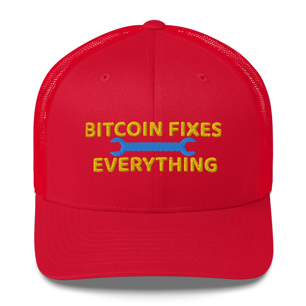 A red UTXO Dreams trucker hat with the text "Bitcoin Fixes Everything" embroidered in yellow, featuring a blue wrench graphic below the text.