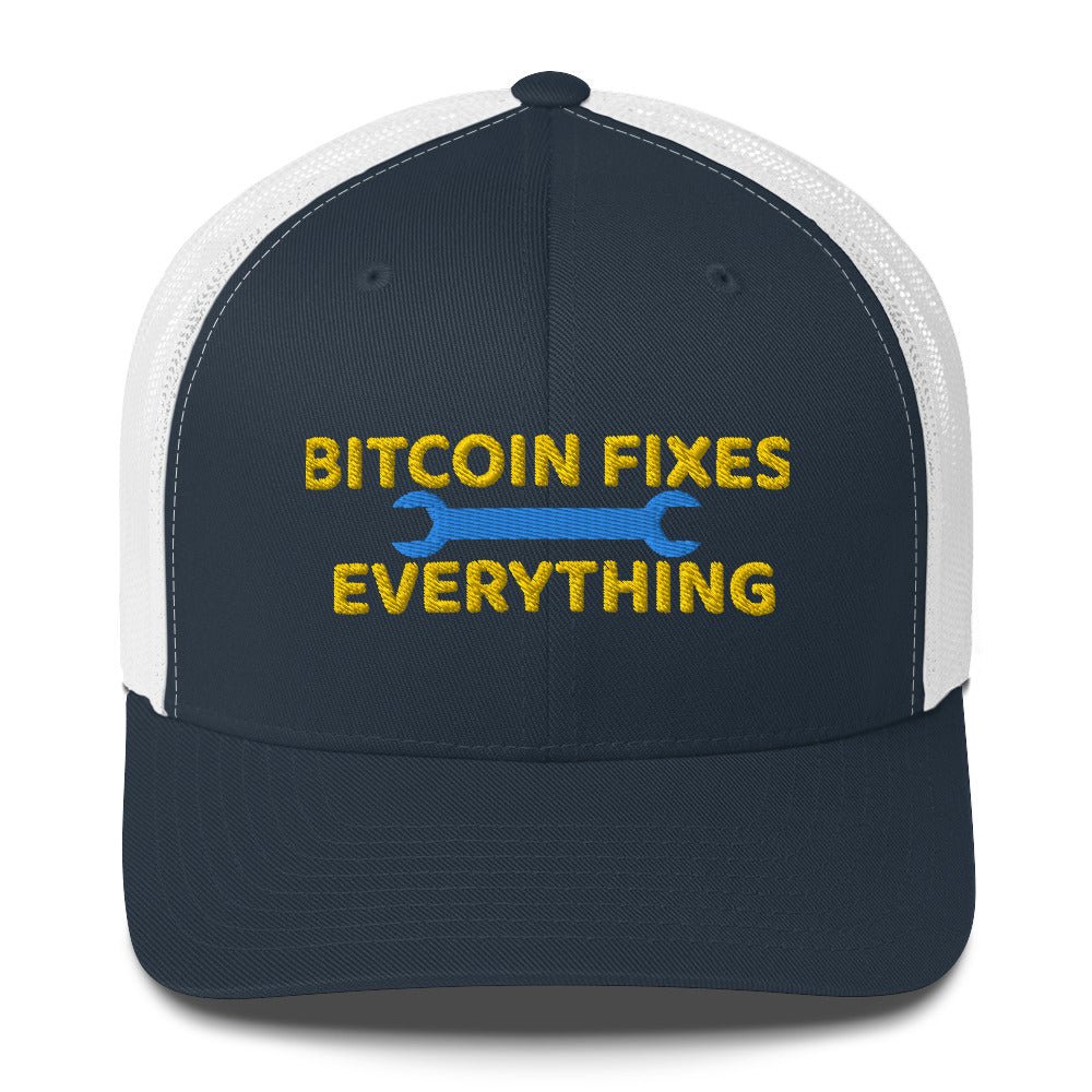 A UTXO Dreams two-tone trucker hat with the slogan "Bitcoin Fixes Everything" embroidered on the front, flanked by wrench graphics, symbolizing the belief in bitcoin as a solution to various problems.