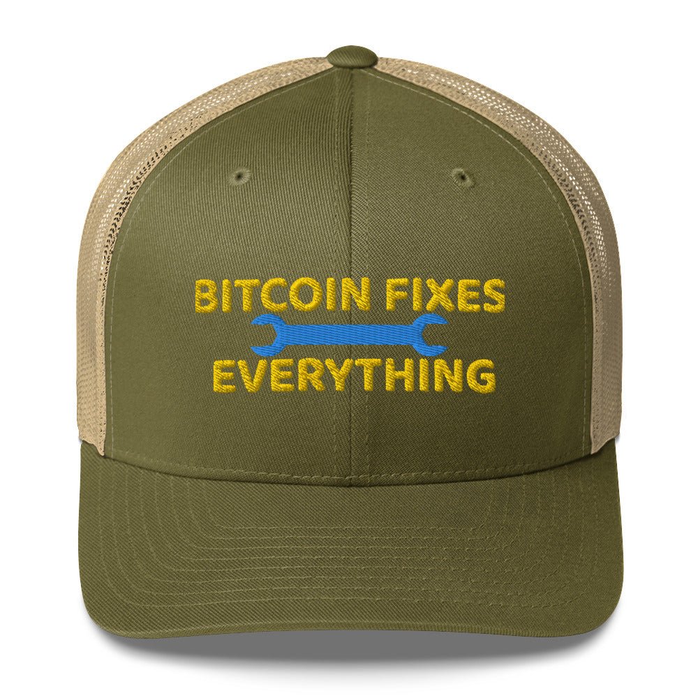 A khaki and olive Bitcoin Fixes Everything Trucker Cap by UTXO Dreams with the phrase embroidered on the front, accompanied by a graphic of a wrench.